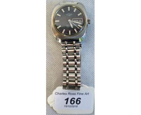 A Rotary gents quartz wristwatch, the rectangular case housing circular dial with baton numerals, day and date aperture on a 