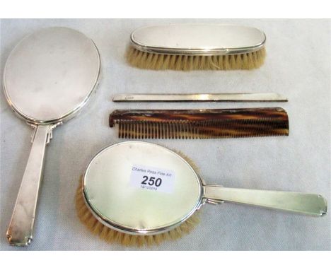 A silver backed dressing table set with engine turned decoration in the Art Deco-style, consisting: mirror, brush, clothes br