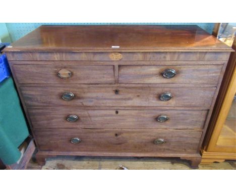 A Georgian mahogany chest of two short over three long drawers on ogee bracket feet.