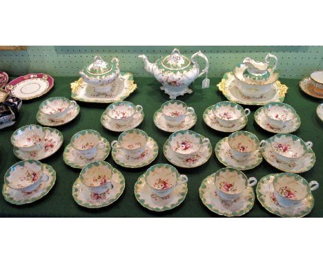 A late 19th century tea service, possibly Minton, comprising: teapot, two cake plates, sugar bowl, milk jug and sixteen vario