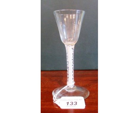 A 19th century drinking glass with tapering bowl, on ribbon and lattice single helix stem and conical base, 15cm tall.