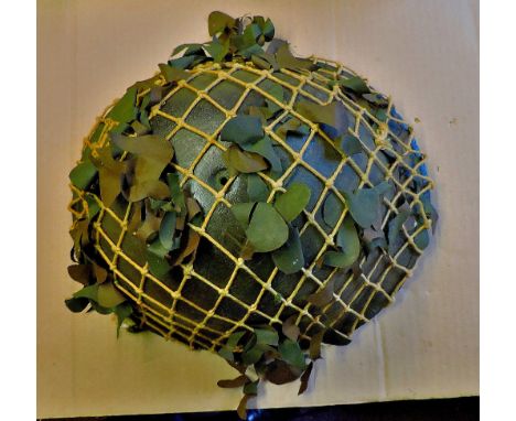 British Army MKIV Helmet with camouflage netting, missing its in-liner.