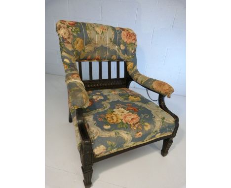 Ebonised nursing chair with upholstered open arms and splat back. Architectural column type legs.  