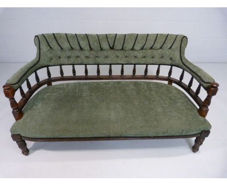 Early Victorian mahogany sofa with turned wooden Galleried back and later upholstery. 