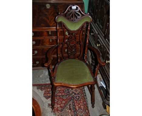 A good quality art nouveau Salon Elbow Chair, shaped and pierced fret-cut top rail over shaped nailed upholstered back pad, o