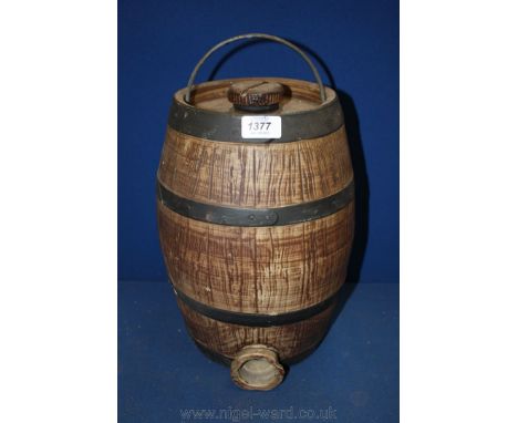 A ceramic wood effect Sherry Cask with iron handle, threaded cap to the top and bung hole to the base
