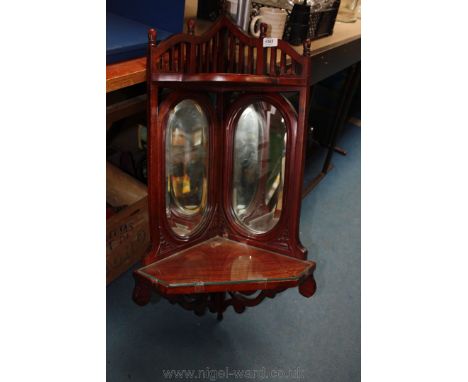 A corner, mirrored glazed Shelf