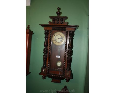 A 19th c. Mahogany cased Vienna Wall Clock having central finial to the platform pediment top, the single pane door having ha