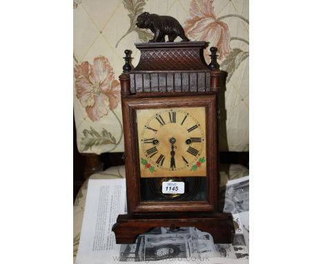 A late 19th c. Oak cased Mantle Clock having finely carved Black Forest style bear to the top, on moulded plinth, flanked by 