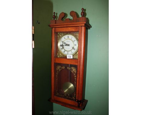 A modern Mahogany cased Wall Clock by Lincoln, having finials and stylised swan pediment top, white Roman numeral face with b