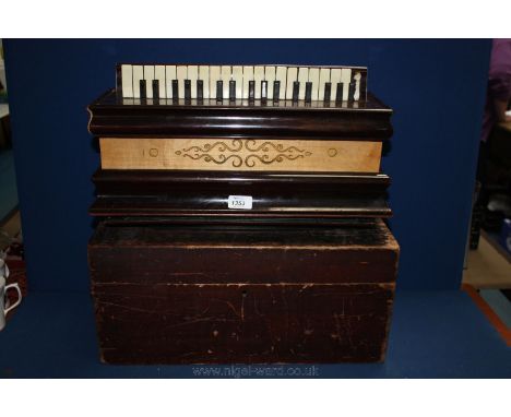 A boxed French Piano Accordion by Busson Brevitte, Paris with ebony and ivory keys, one ivory missing