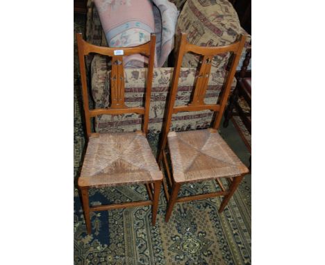 An Elegant pair of Art Nouveau satinwood Bedroom Chairs having shaped top rails, both having single splat backs with fret-cut