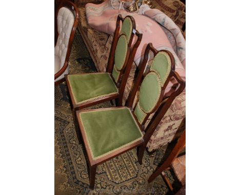A pair of art nouveau Mahogany Hall Chairs having slender square form shaped backs with triple pad backs, applied seats, stan