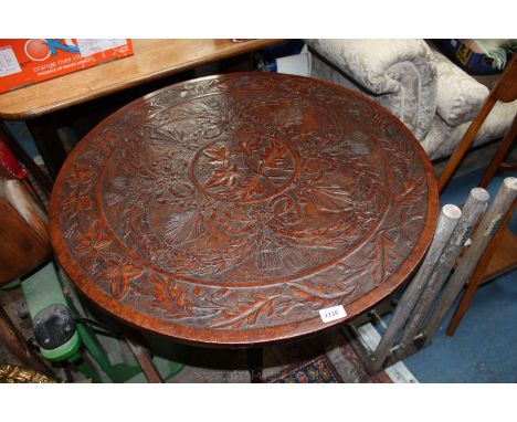 An interesting antique Mahogany tripod Occasional Table having circular tilt-top, carved with leaves, shells, swags and bows,