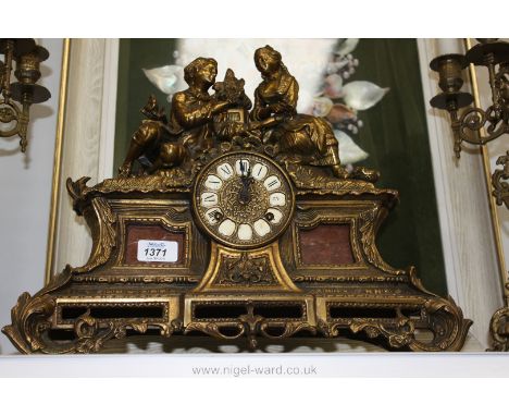 An ornate late 19th c. gilt German Mantel Clock by Franz Hermle & Sons. of Goshen/Wurttemberg, Germany, with figures of a lad
