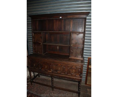 A Priory style Dresser, the plate rack having moulded cornice over shelf over shorter shelf flanked by twin panel opposing do