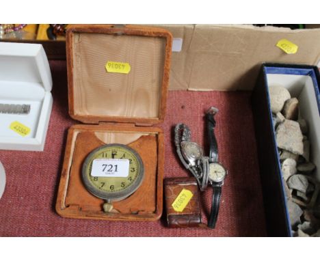 A Tissot wrist watch, two travel watches and another wrist watch