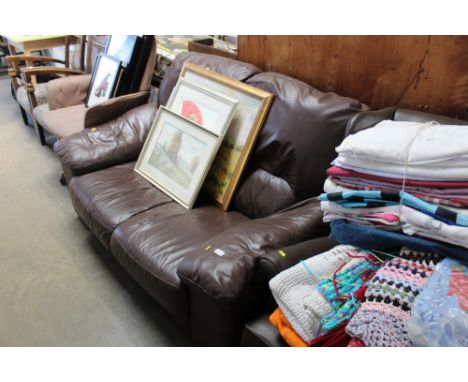 A brown upholstered two seater settee