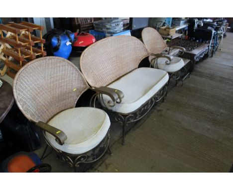 A vine decorated conservatory suite comprising of two seater settee and a pair of matching armchairs 