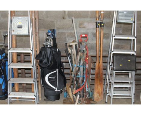 A bundle of various long handled gardening tools 