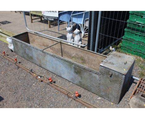 A large galvanised water trough approx. 8ft long