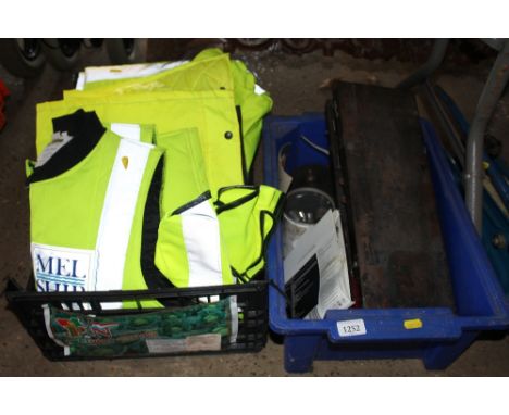 A box of hi-viz clothing and various tools 