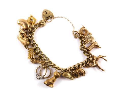 A 9ct gold curb link charm bracelet, with fourteen charms as fitted, on a heart shaped padlock, with safety chain as fitted, 