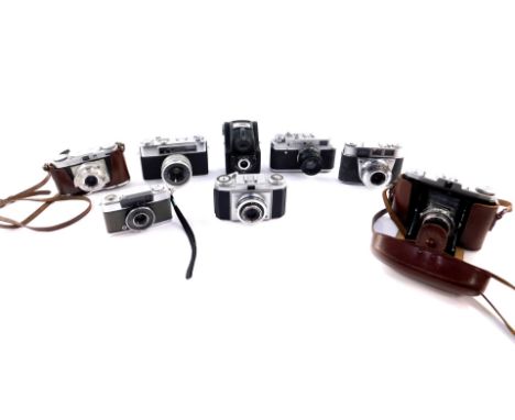 A group of cameras, including a Zorki - 4 camera, two Zeiss Ikon cameras, Edixa Wirgin camera, and a Yashica Minister III cam