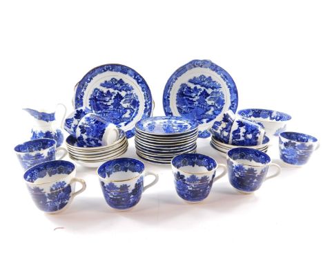 A late 19thC pottery part tea service, transfer decorated in blue and white with a chinoiserie landscape, gilt heightened, co