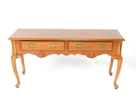 An 18thC style light mahogany and yew wood cross banded side table, with two frieze drawers and a shaped apron carved with sh