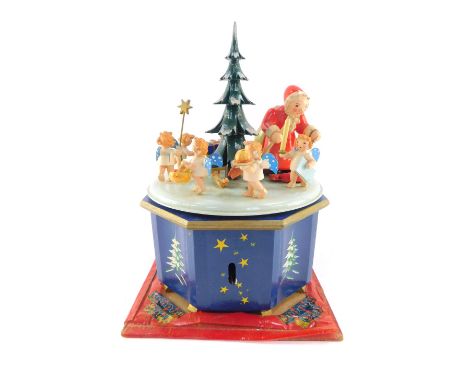 A mid 20thC Steinbach Christmas carousel, playing Stille Nacht and O Tannenbaum, the carousel decorated with a Christmas tree