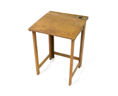 An early 20thC oak child's folding gate leg desk, with pen and ink well recesses and drop flap writing surface, 77cm H, 56cm 