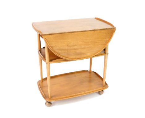 An Ercol light elm three tier trolley, the top with drop flaps, raised on turned supports, on castors, 75cm H, 73cm W, 44cm D