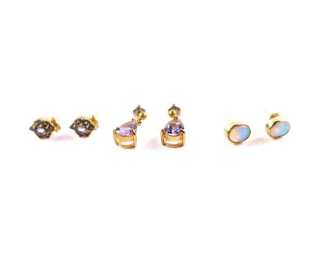 A pair of 9ct gold and garnet set cluster earrings, with certificate, pair of yellow metal and amethyst earrings, and a pair 