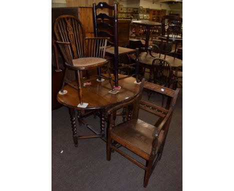 An oak drop leaf dining table; a Georgian armchair; a cane seated beech armchair; and a ash ladder back chair (4)