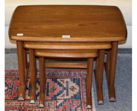 A nest of Ercol oak tables with faceted legs, Golden Dawn design 
