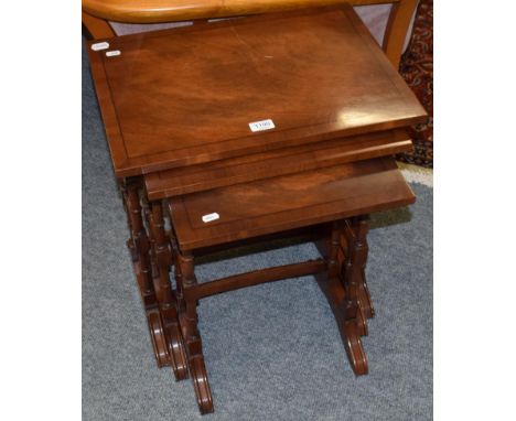 A reproduction walnut drop leaf coffee table, a nest of three tables, and a mahogany three tier hanging shelf