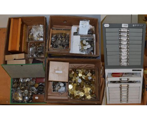A large quantity of pocket watch and wristwatch dials and movements; nickel plated pocket watch cases; and two metal drawer c