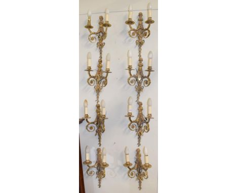A set of eight gilt metal twin-light figural wall sconces, decorated with musical putto 