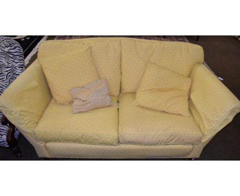 A mahogany framed two seater sofa upholstered in mustard yellow fabric