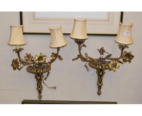 A pair of gilt metal three light wall sconces in the form of pierced urns issuing floral branches
