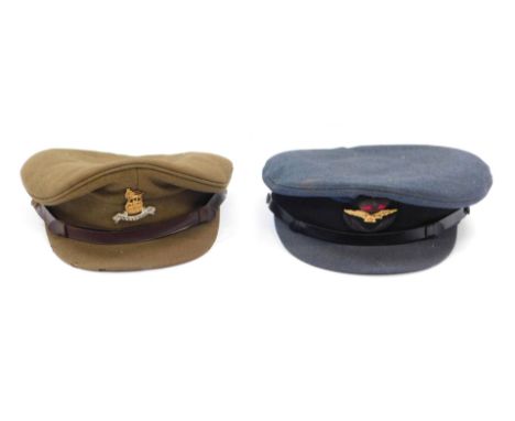 Two military peaked caps, comprising an RAF cap and a Royal Army Pay Corps cap from Reid Bros, London.