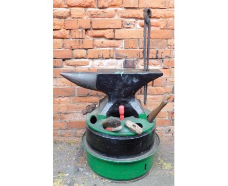 A iron anvil, on adapted home made stand, formed of two tyre inners, with tool sections and small quantity of tools.