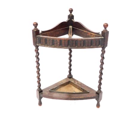 An early 20thC mahogany corner stick stand, with two section support, with metal drip tray, 76cm high.