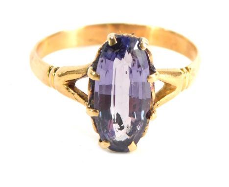 An amethyst dress ring, with oval amethyst in eight claw setting with V splayed rib design shoulders, yellow metal stamped 75