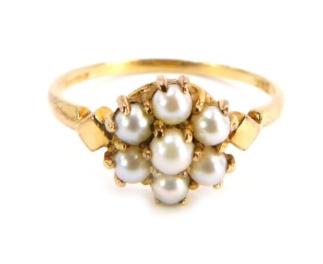A 9ct gold cultured pearl cluster ring, the cluster set with six cultured pearls with diamond shaped shoulders, on a plain ba