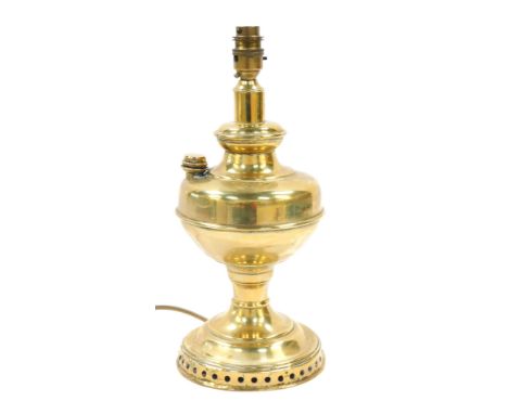 A brass oil lamp, with reservoir, on a pierced rim, converted to electricity, 36cm high.