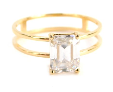 A single stone moissanite dress ring, the rectangular cut and faceted moissanite with four claw basket setting on two splayed
