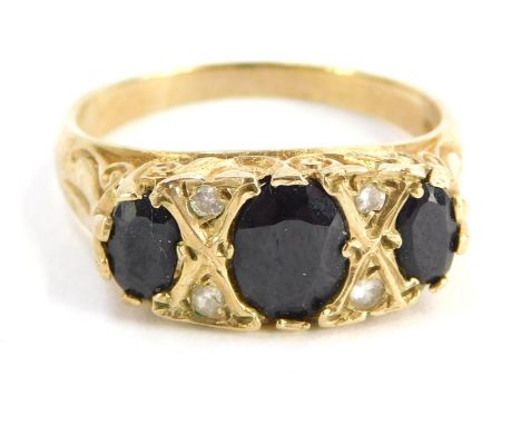 A 9ct gold gypsy ring, set with three dark blue stones and four CZ, size O½, 3.7g all in, boxed.