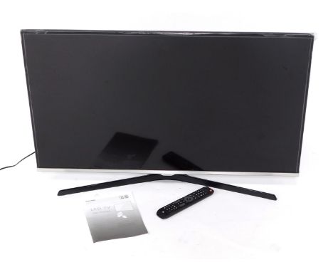 A Samsung 39" smart TV, model UE40J5100AK, with instruction manual and remote control. 